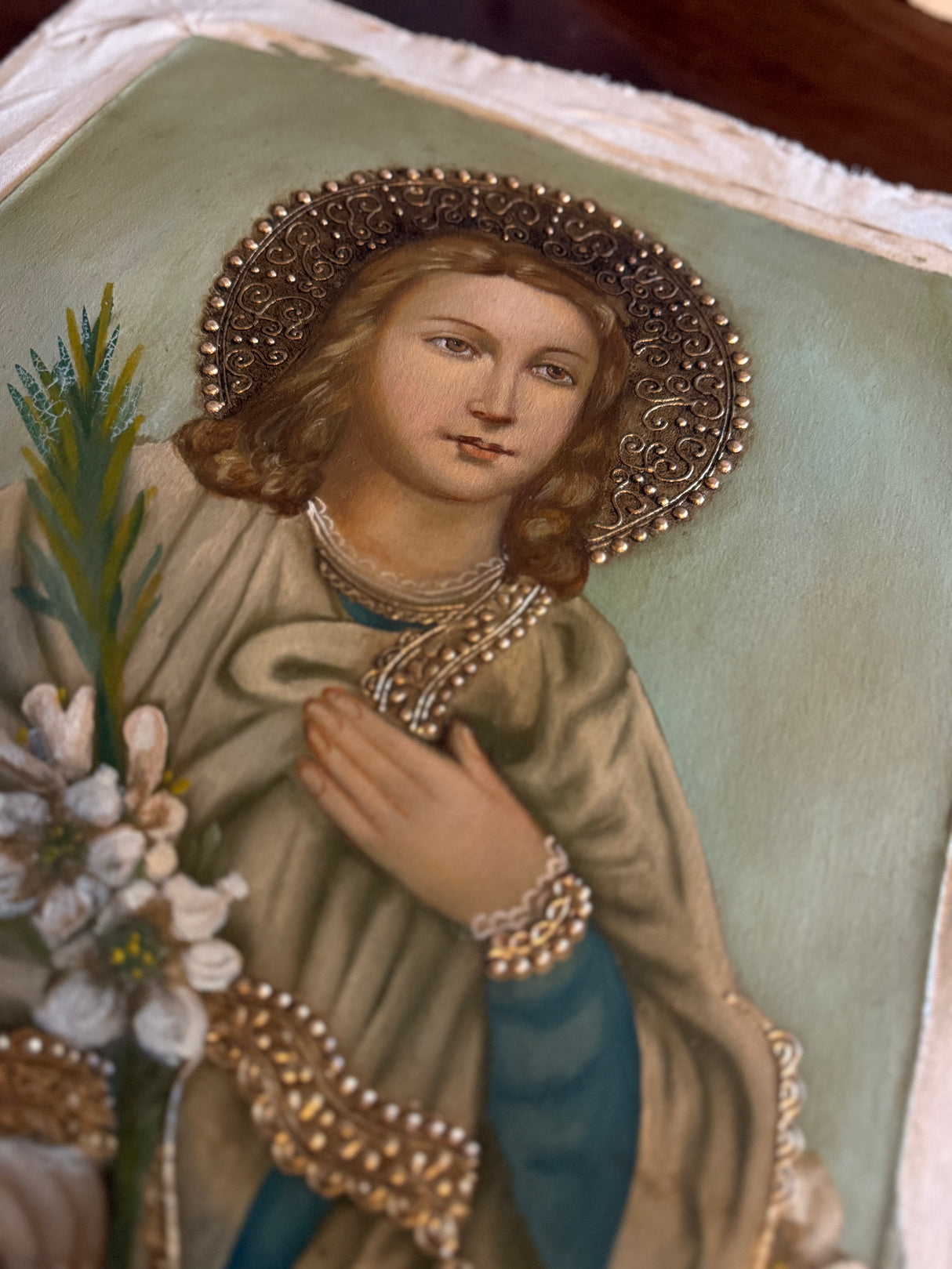 Close-up of Saint Maria Goretti with gold detailing